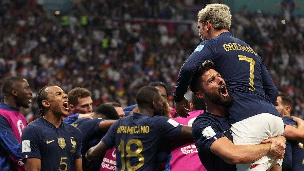 Olivier Giroud celebrates with Antoine Griezmann and his teammates the winning goal against the English