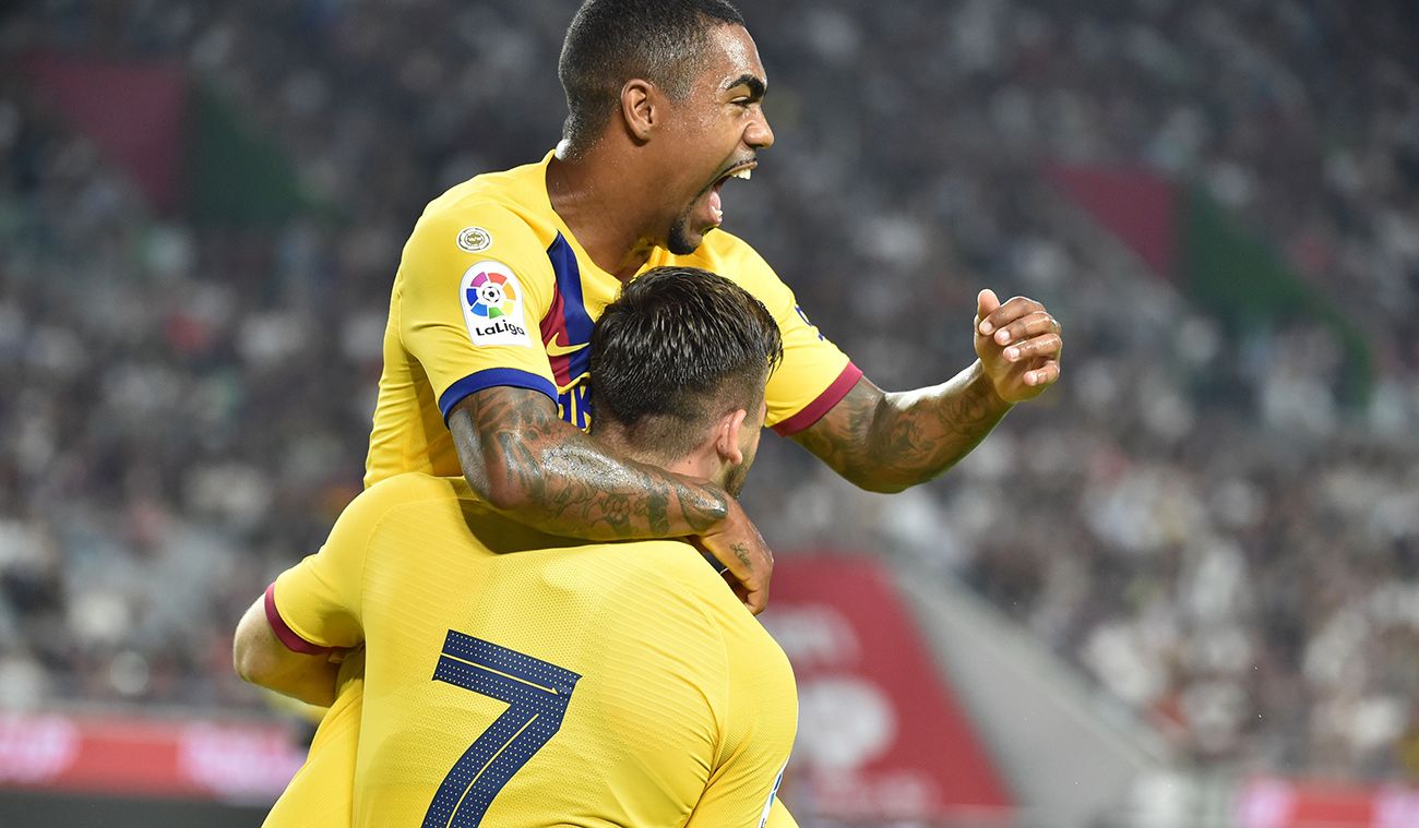 Malcom and Carles Pérez, celebrating a goal with FC Barcelona