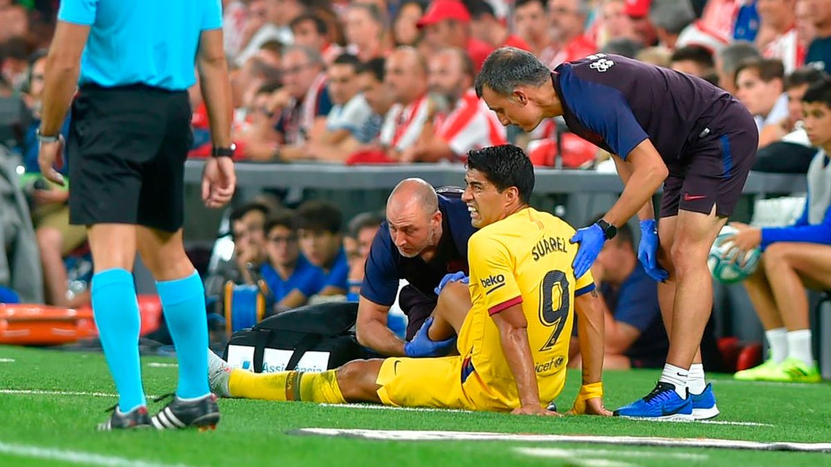 Luis Suárez reacts after getting injured in a match of Barça