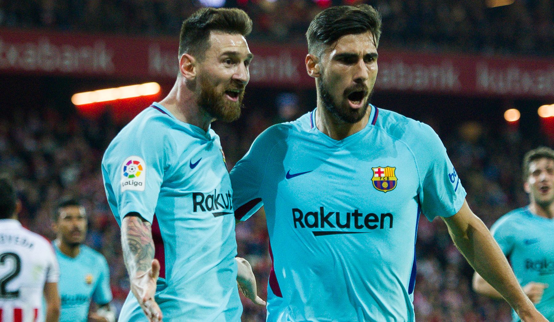 Messi and André Gomes celebrate a goal with the Barça