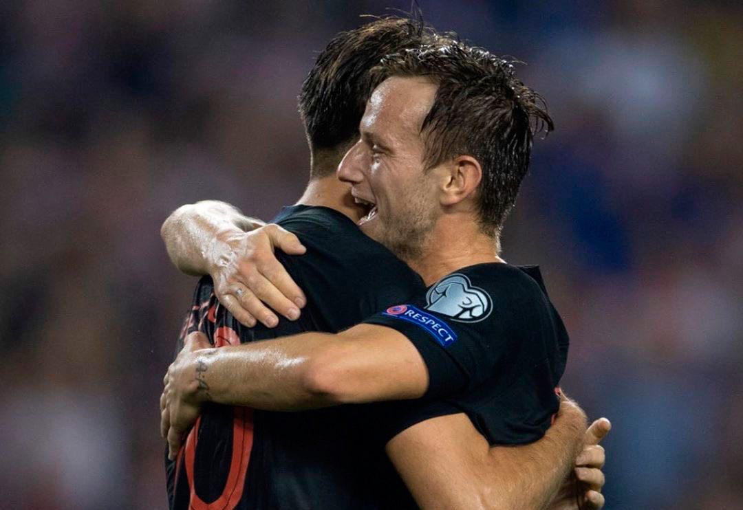 Ivan Rakitic celebrates a goal with a mate of Croatia