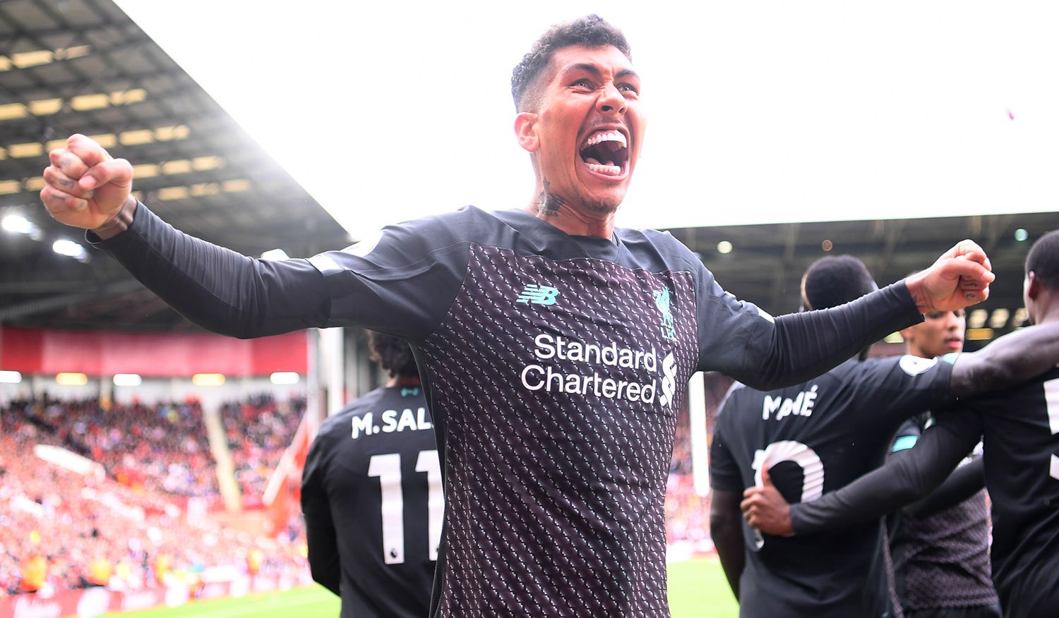 Roberto Firmino celebrates a goal with the Liverpool
