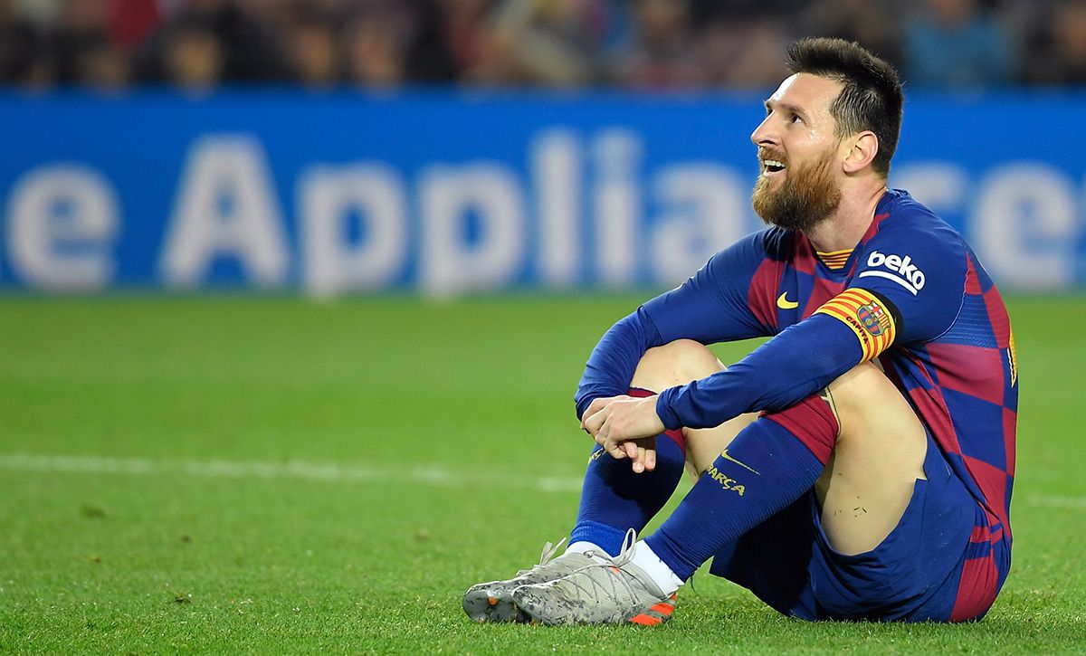 Leo Messi, seated on the lawn of the Camp Nou