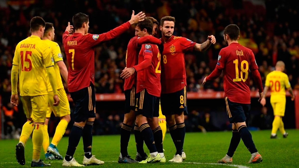The players of Spain celebrate a goal against Romania