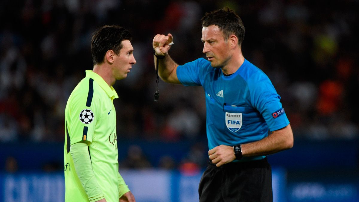 The international referee Mark Clattenburg in a Champions League match with Leo Messi