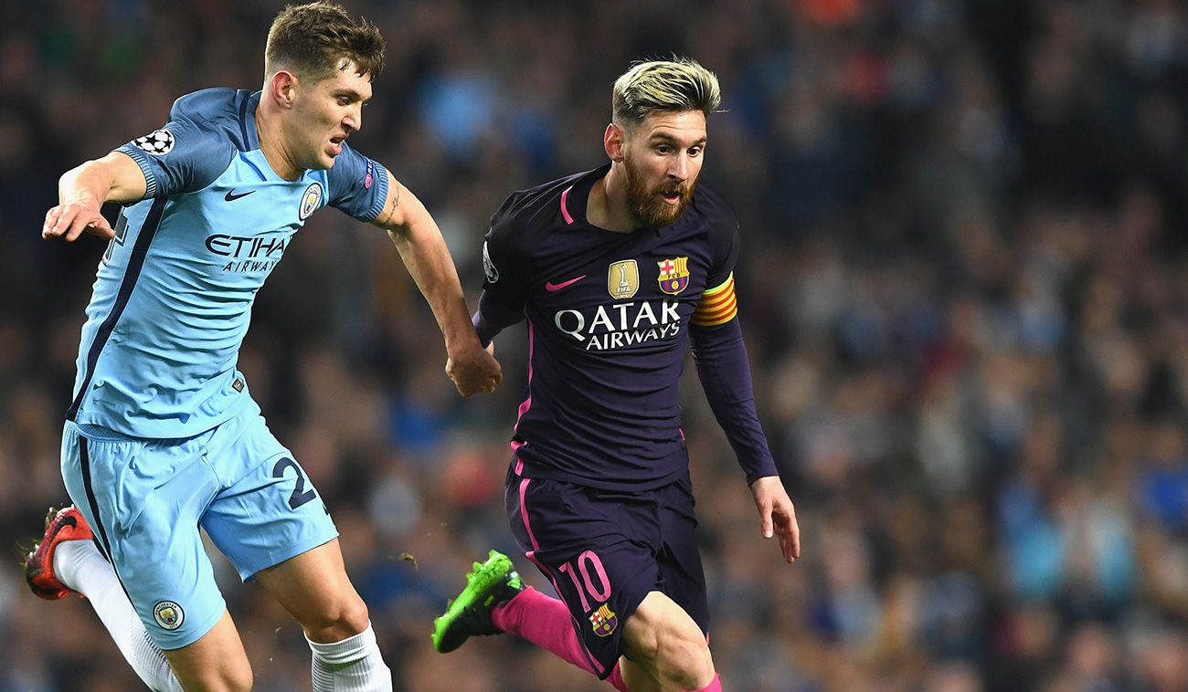 Leo Messi runs beside Stones, of the City