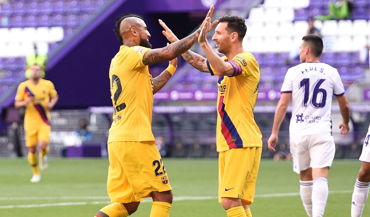 Leo Messi and Arturo Vidal bump  after a goal