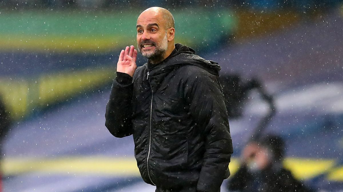 Pep Guardiola gives an indication under the rain