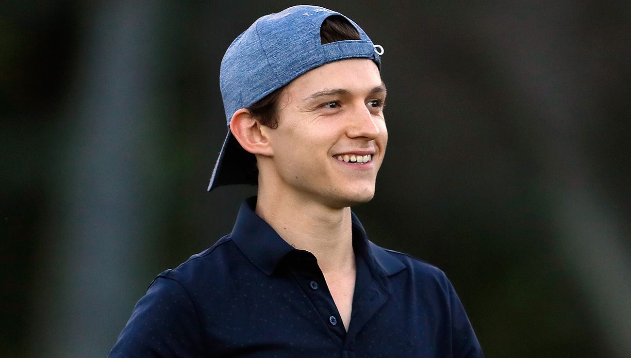 Tom Holland in an act in a field of golf