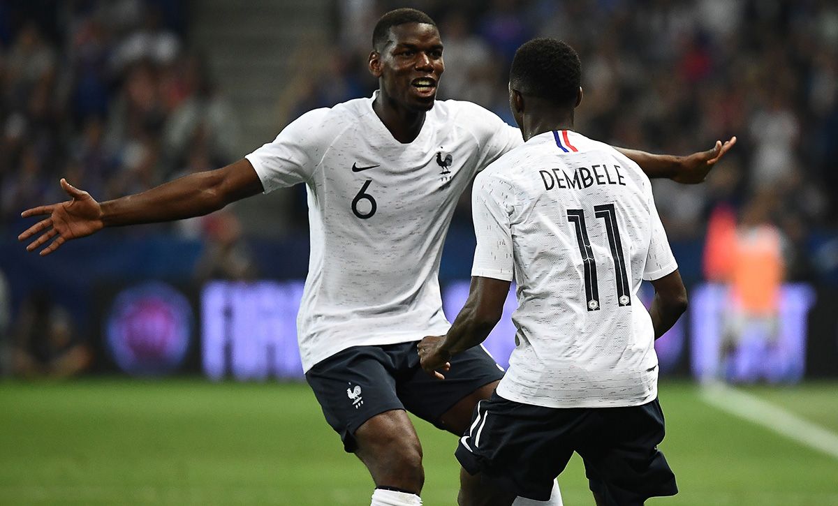 Ousmane Dembélé and Paul Pogba, hugging after a goal with France