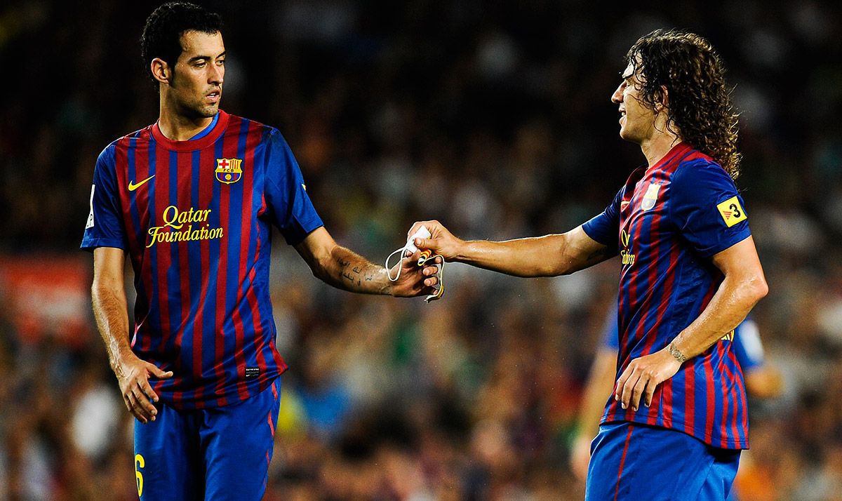 Sergio Busquets y Carles Puyol, durante un partido con el FC Barcelona