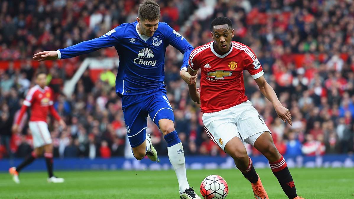 John Stones, contesting a balloon with Anthony Martial