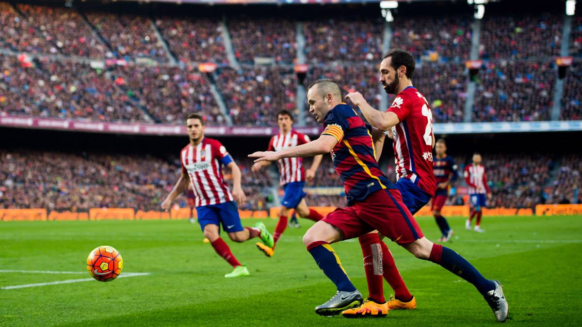 Iniesta, progressing in front of Juanfran to the centre of the field