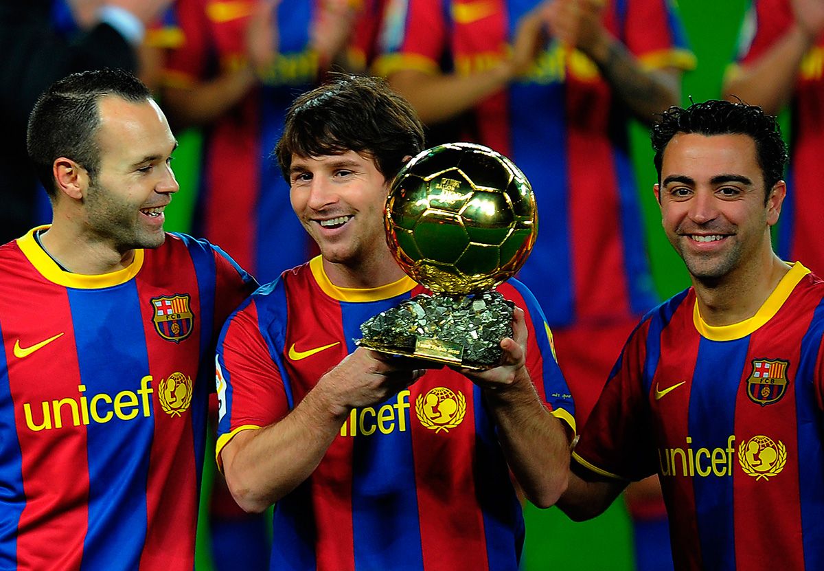 Messi Xavi and Iniesta with the Balloon of Gold