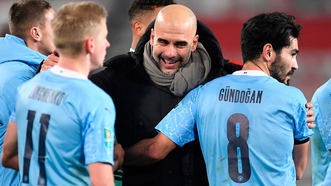 Pep Guardiola embraces to his players