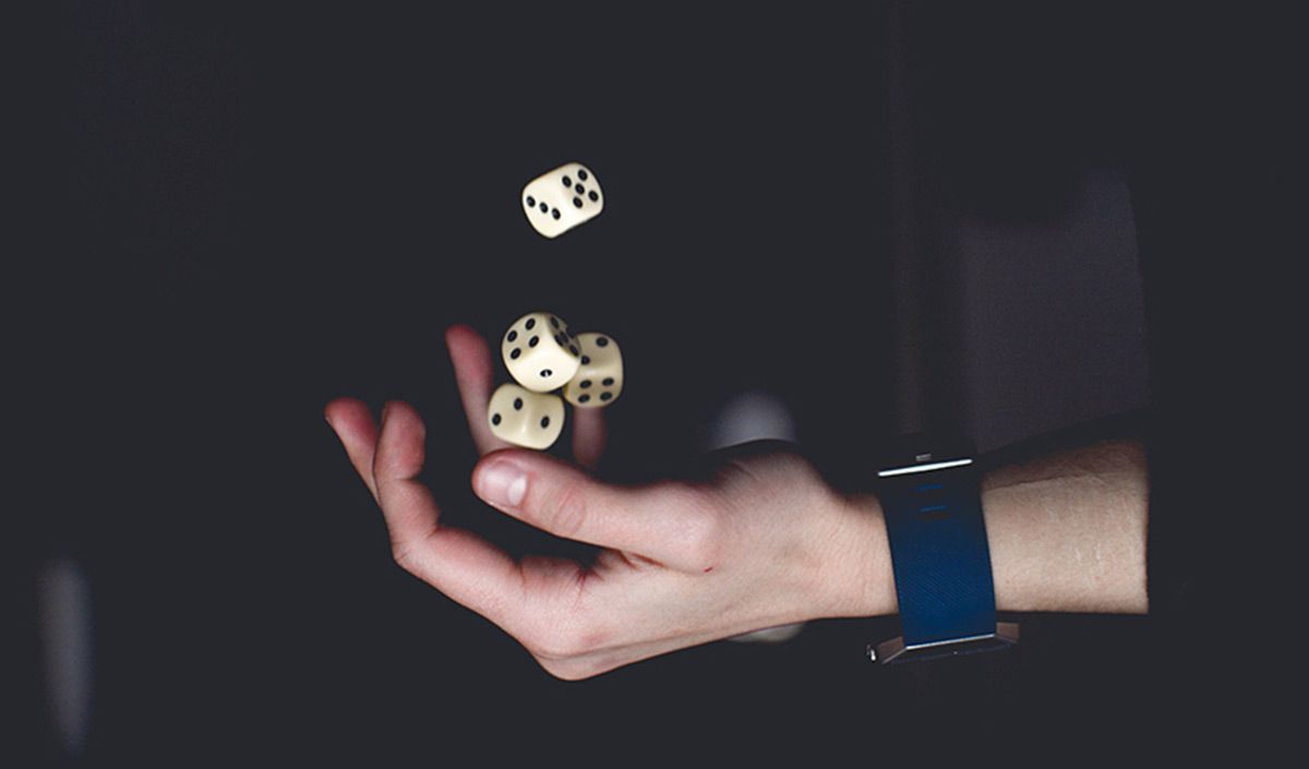 A hand throwing to the air some dice: The luck is thrown