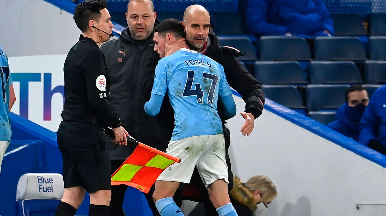 Pep Guardiola embraces to Phil Foden after a change