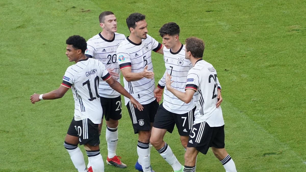 The players of Germany celebrating a goal in front of Portugal