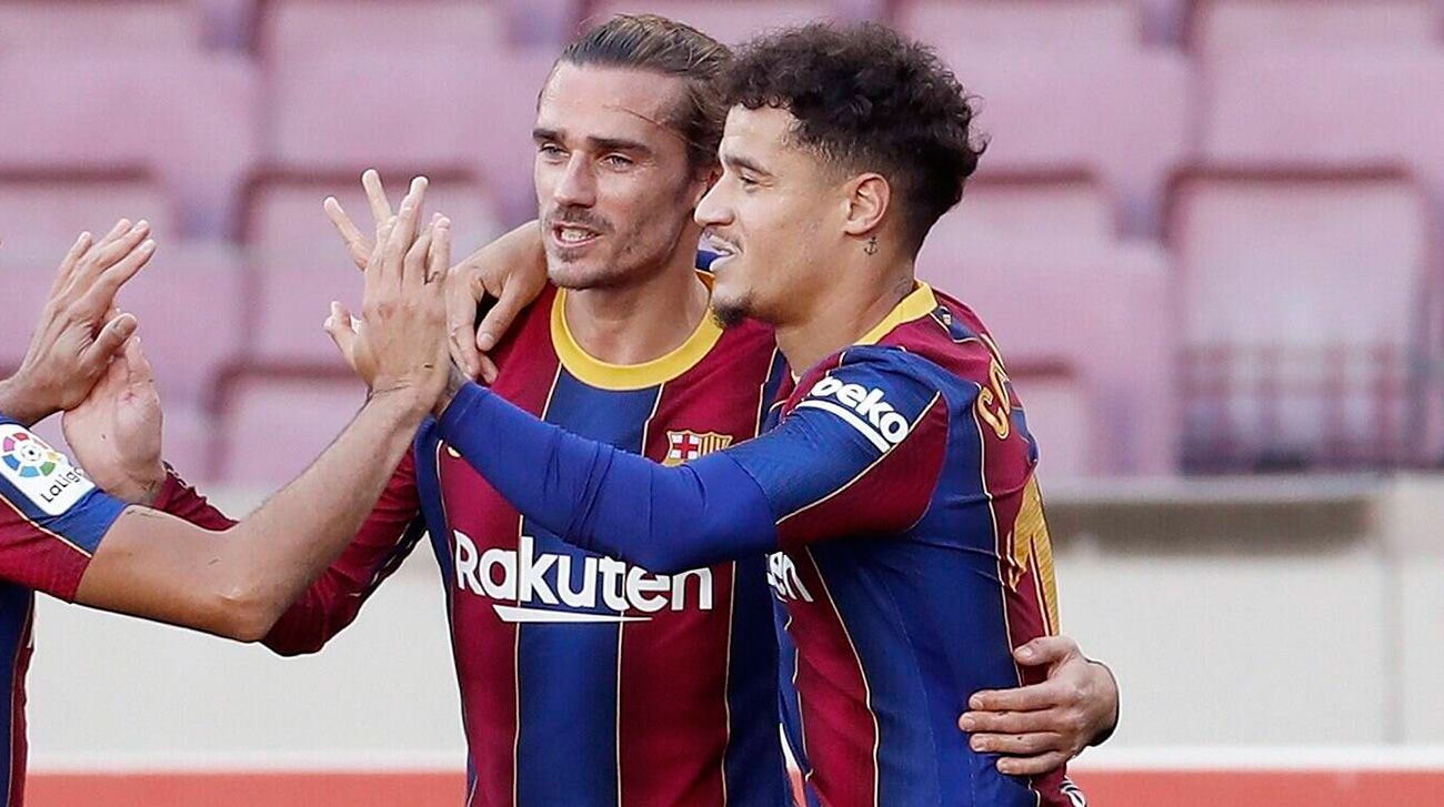 Griezmann And Coutinho celebrate a goal