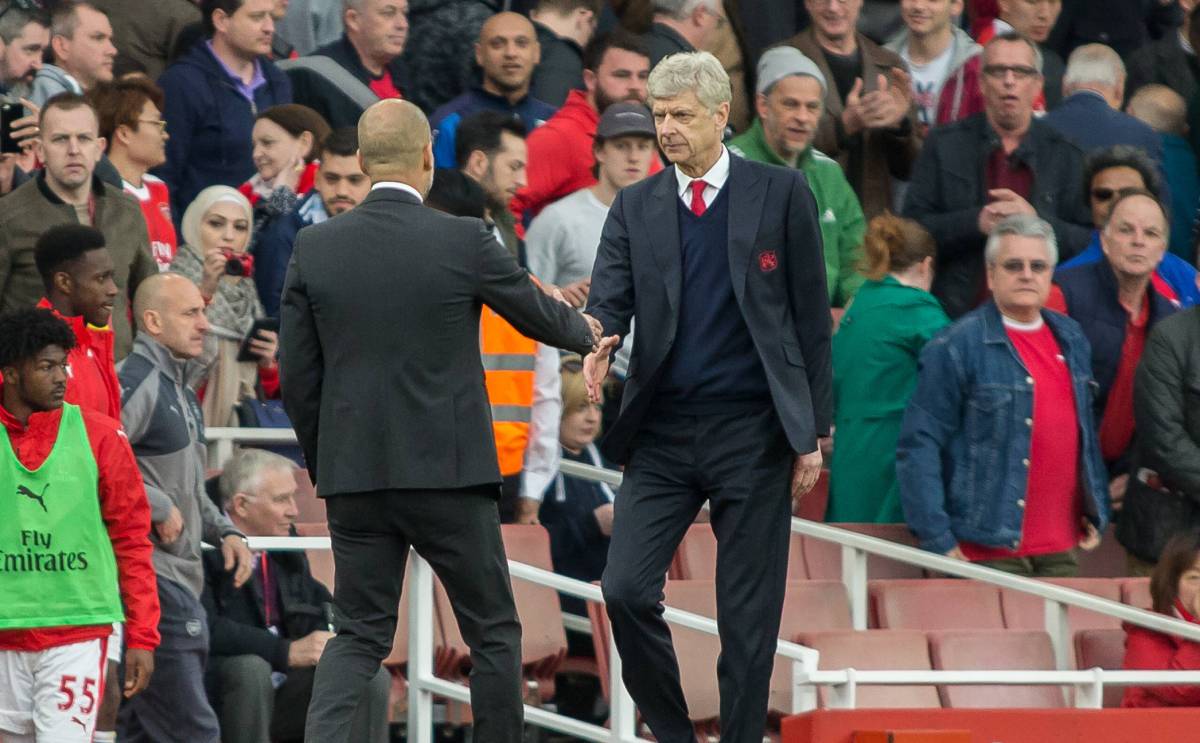 Pep Guardiola and Arsène Wenger greet  after a party of the Premier