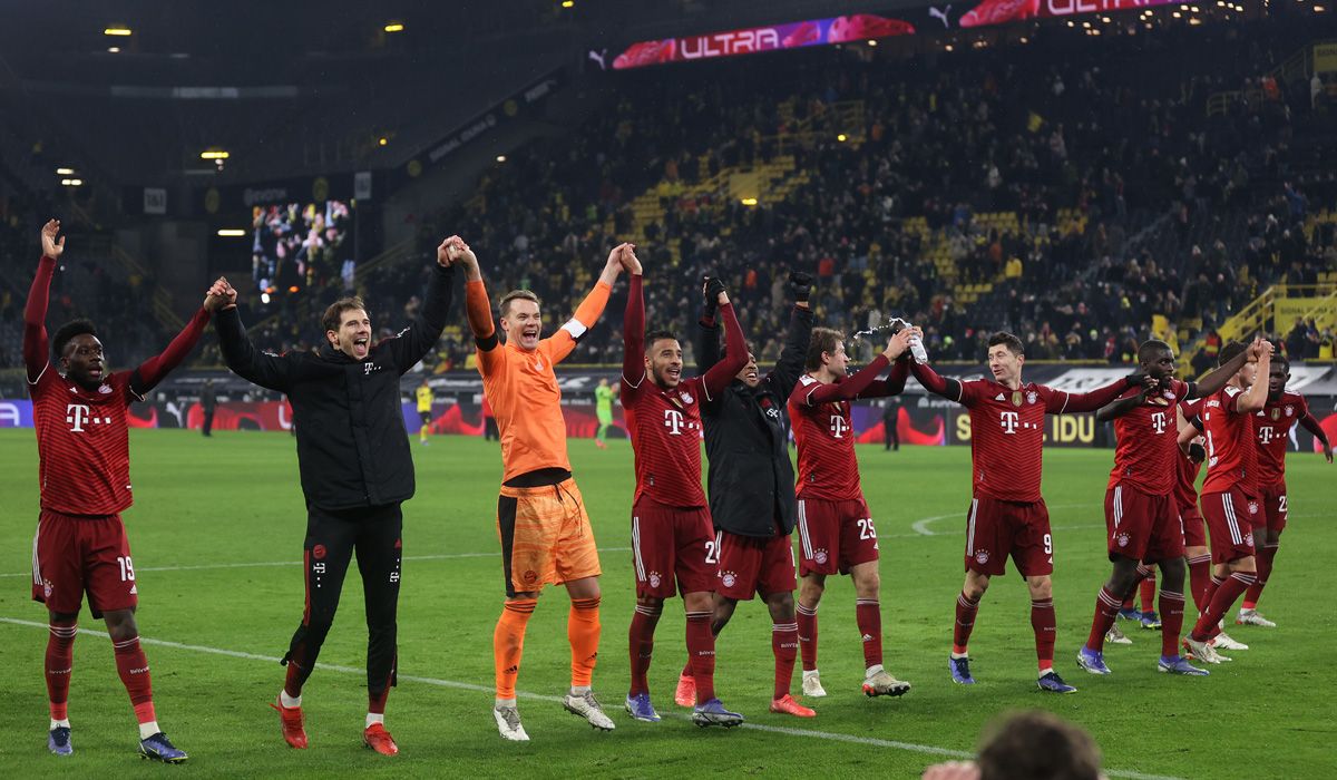 Players of the Bayern Munich celebrate the victory in front of the Dortmund