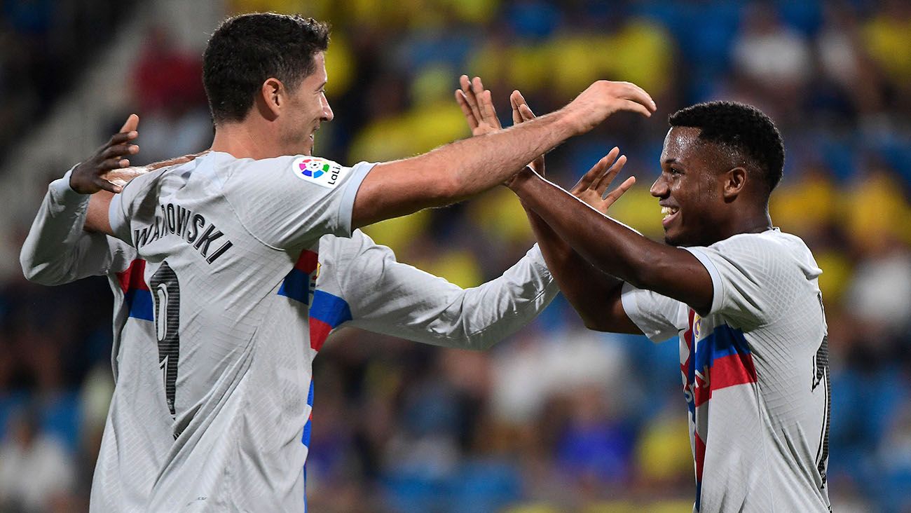 Ansu Fati and Robert Lewandowski celebrating a goal with Barça