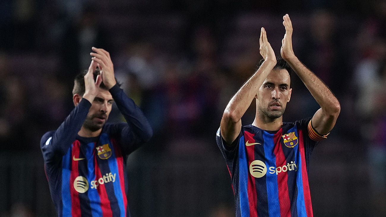 Piqué and Busquets applauding the stands