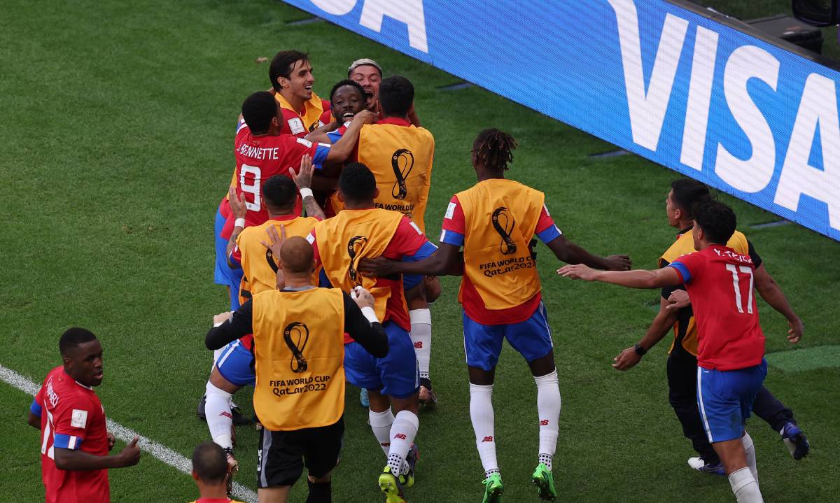 Costa Rica players celebrate their goal v Japan