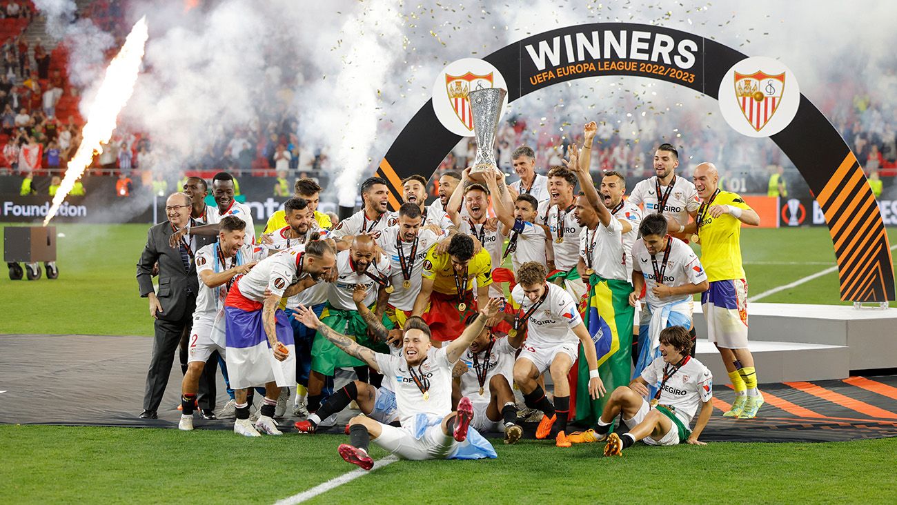 Sevilla players celebrate with the Europa League trophy