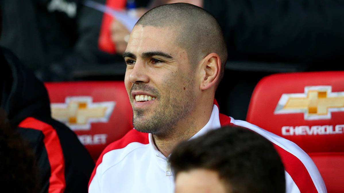 Víctor Valdés, sentado en el banquillo del Manchester United