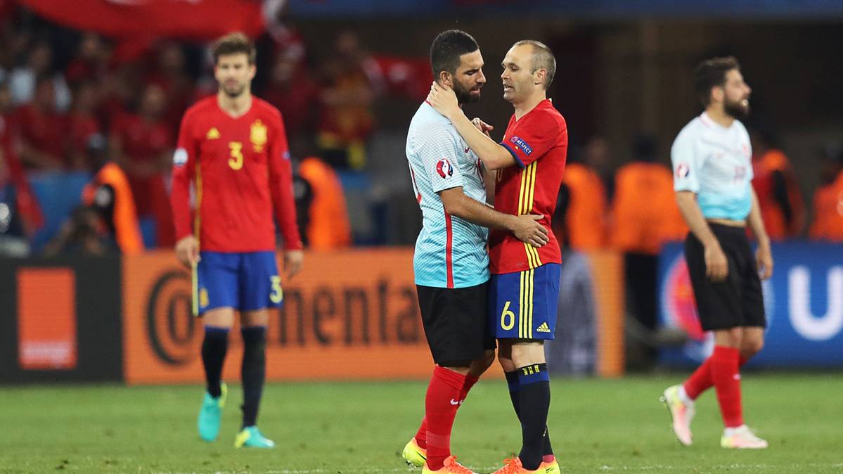 Arda Turan, siendo consolado por Iniesta al final del partido