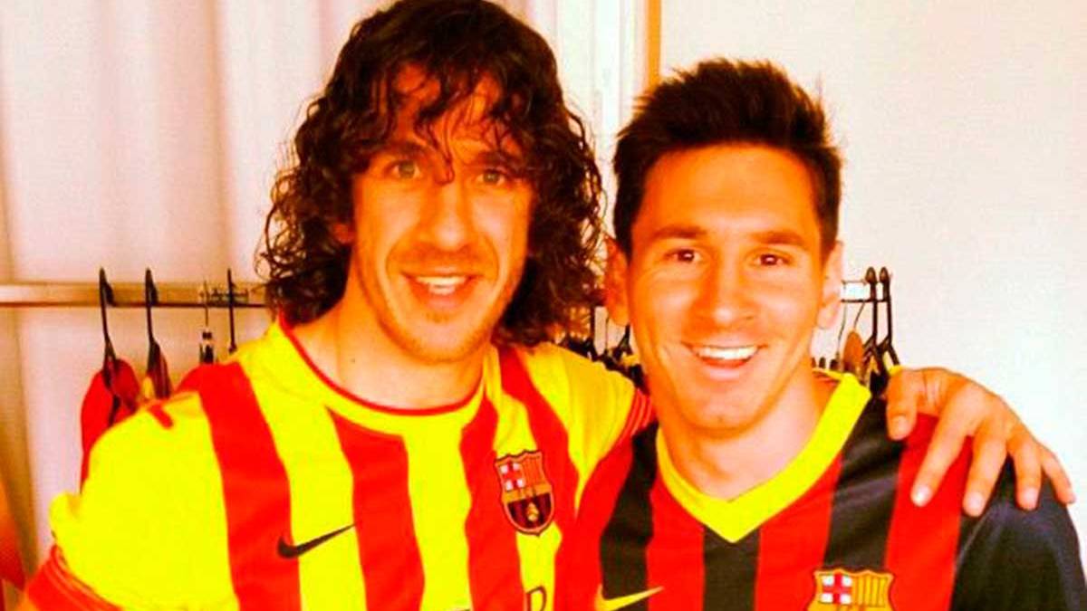 Carles Puyol beside Leo Messi