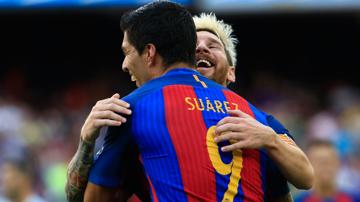 Leo Messi and Luis Suárez, celebrating a goal against the Betis