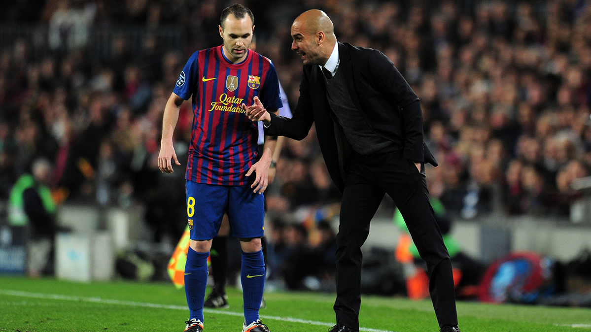 Andrés Iniesta beside Pep Guardiola during a party of the Barça