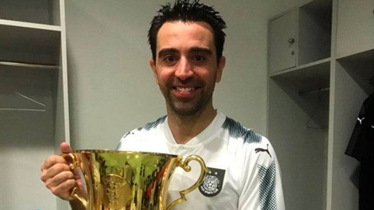 Xavi Hernández poses with the Supercopa of Qatar