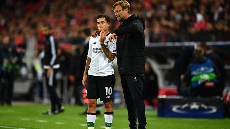 Philippe Coutinho in a party of Champions beside Jürgen Klopp