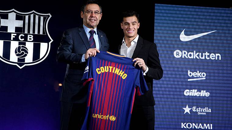 Philippe Coutinho, posing beside Bartomeu with the T-shirt of the Barça