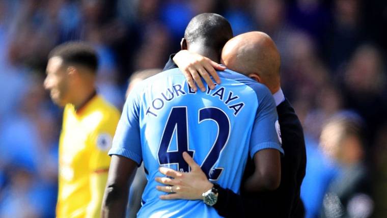 Touré Yaya And Pep Guardiola, embracing after a party of the City