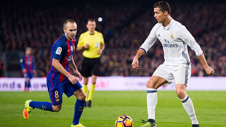 Andrés Iniesta, struggling by a balloon with Cristiano Ronaldo