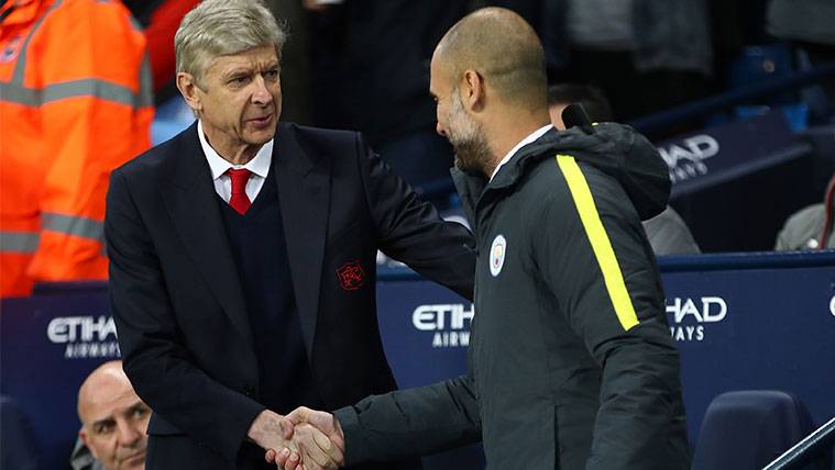 Arsène Wenger and Pep Guardiola greet  before a party