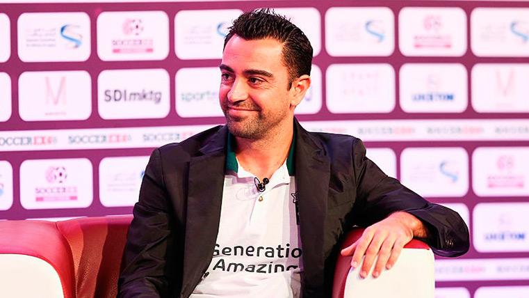 Xavi poses in an interview