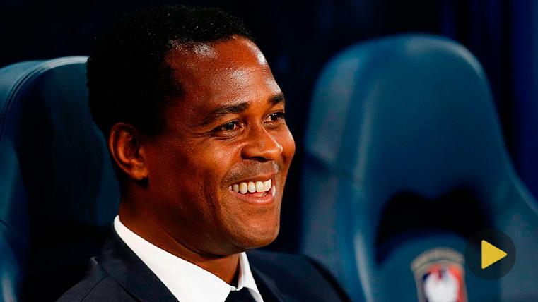 Patrick Kluivert smiling in a bench