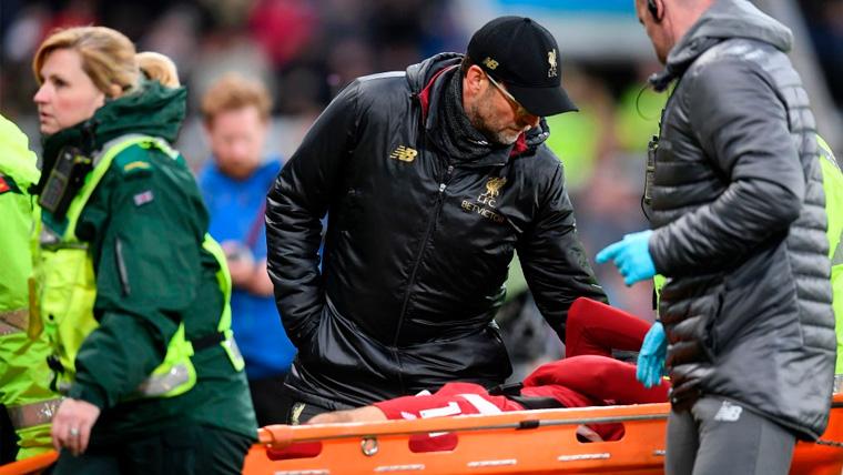 Jürgen Klopp speaks with Mohamed Salah while they withdraw him in stretcher