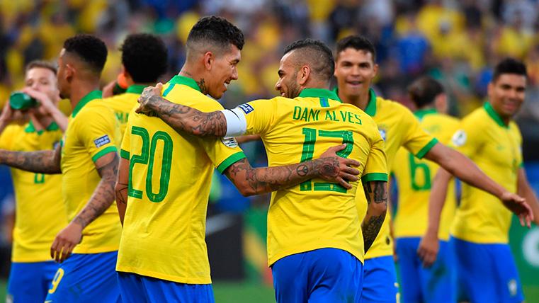 Firmino and Alves celebrate a goal with Brazil