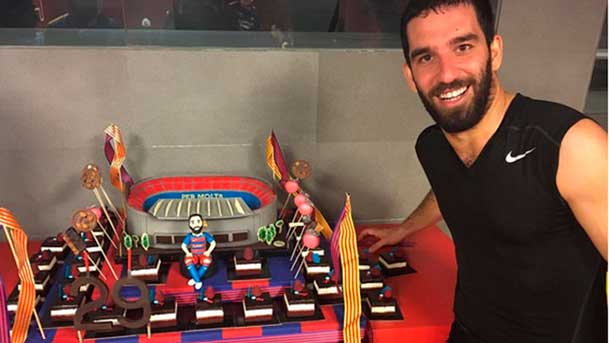 The staff of the fc barcelona surprised to burn turan with a big cake the day of his birthday