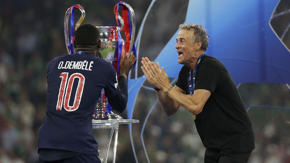 Ousmane Dembélé and Luis Enrique, next to the UEFA Champions League trophy Ousmane Dembélé and Luis Enrique, next to the UEFA Champions League trophy