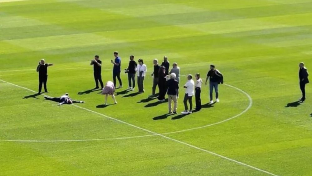 Joan Laporta lying on the Camp Nou pitch